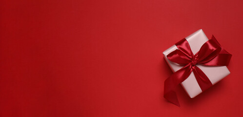 Beautiful gift box on red background