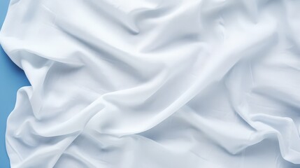 Obraz premium Crumpled White Cotton Fabric with Natural Texture on a Blue Background for Use in Various Design Projects and Textiles