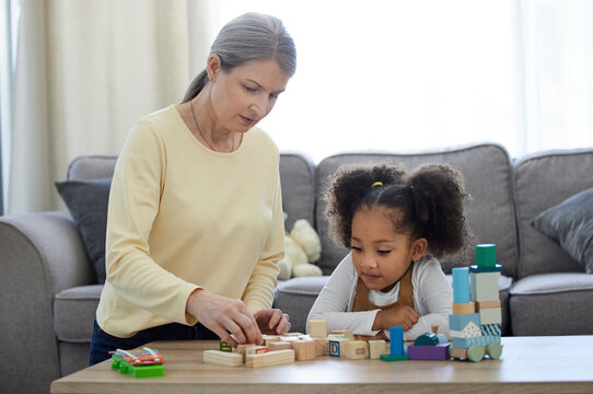 Psychologist, child and development with toys for education, learning behavior and assessment for adhd. Therapy, mature therapist and girl with blocks for autism, sensory skills and cognitive game