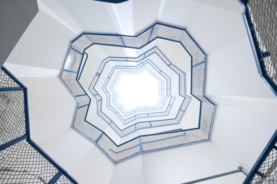 spiral staircase from below octagonal shape blue railings mesh