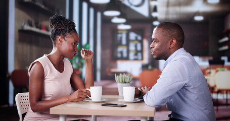 Laughing Male And Female Sitting In Cafe Drinking Coffee
