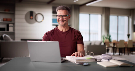 Fototapeta premium Man Doing Taxes And Family Budget