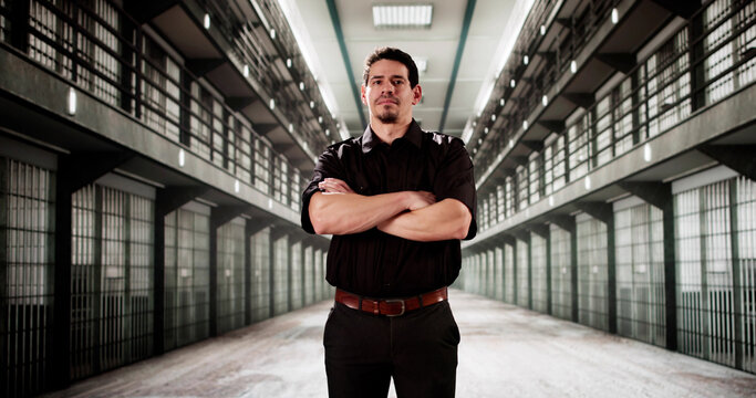 The prison guard stood sternly in front