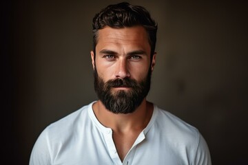 Fototapeta premium Close up portrait of a bearded man exuding confidence and style against a dark background