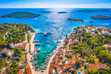 A stunning aerial view of Maslinica on &Scaron;olta Island, Croatia, showcasing its picturesque harbor, charming village center, and the scenic archipelago of small islands in front, surrounded by the sea