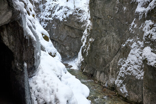 Frozen Winter Gorge with Flowing Stream