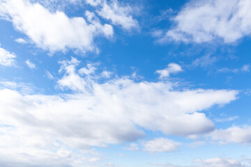 Naklejka premium Blue heaven dotted with fluffy, white clouds. A perfect summer day sky