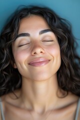 Fototapeta premium A portrait of a woman with her eyes closed, focus on facial expression