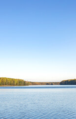Fototapeta premium Calm lake with a blue sky in the background