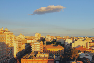 City and a cloud at sunset. Catania, Sicily, Italy