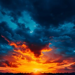 Fototapeta premium Fiery Sunset Sky with Dark Blue Clouds
