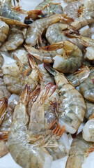 Selling raw shrimp in a supermarket. Fresh raw shrimps at the fish market. Seafood. Raw shrimp close-up