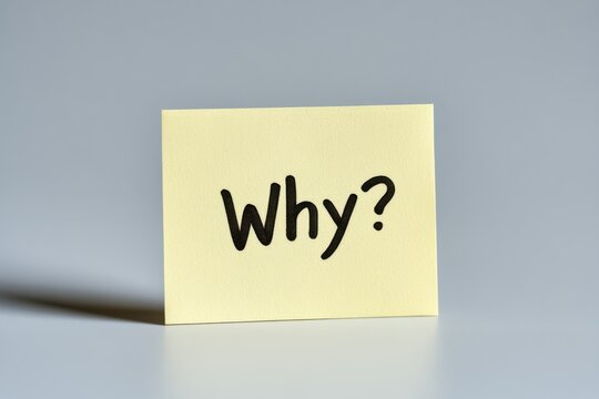 A yellow sticky note captures attention with the bold black letters spelling out Why? in the center, offering a moment of reflection against a clean white background
