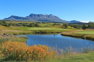 Scenic view of a golf course with mountains and vibrant flowers in a clear blue sky