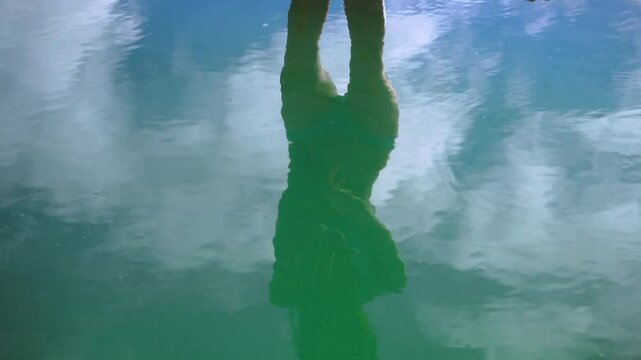 Asian Girl in Bikini is Dancing on the Edge of Natural Petrified Waterfall Hierve el Agua in Mexico, Oaxaca. Reflection.