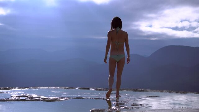 Asian Girl in Bikini is Walking by the Edge of Natural Petrified Waterfall Hierve el Agua in Mexico, Oaxaca. Travelling