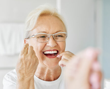 woman tooth bathroom hygiene senior morning routine floss dental care oral mouth product white thread brushing elderly home retirement mirror health cleaning