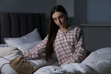 Obraz premium Young woman suffering from sleepwalking on bed at home