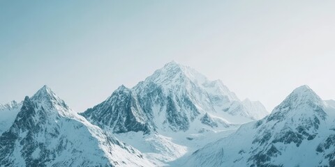 Obraz premium A breathtaking view of majestic snow-capped mountains under a clear blue sky.