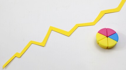 Fototapeta premium Pie chart made of colored wooden cubes with white background copy space.