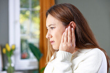 Young woman with ear pain