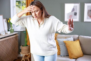 Young woman suffering from vertigo or dizziness problem of brain or inner ear