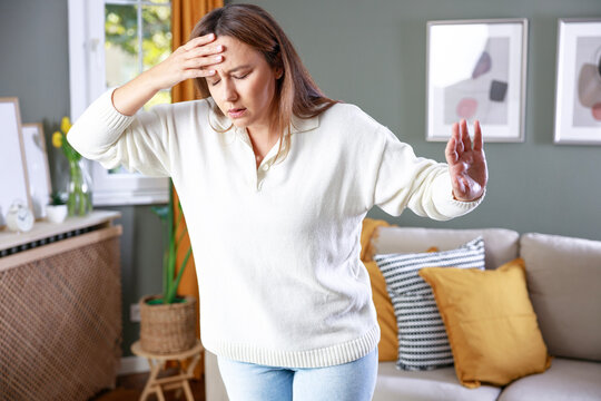 Young woman suffering from vertigo or dizziness problem of brain or inner ear