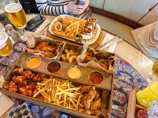 Beer plate with chicken wraps, potatoes,nuggets and variety of sauces
