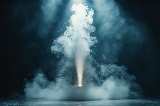 Mysterious fog fills the space as a spotlight breaks through the haze in a dimly lit venue