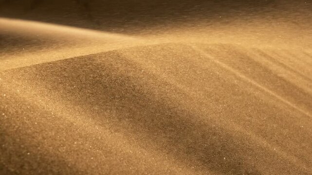 Sands move during desert sandstorm. Golden particles of sand in the wind. Wind carries the sand along the dune in the desert. Slow motion 4K shot