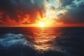 Obraz premium Dramatic sunset over a tranquil ocean with vibrant colors and calm waters