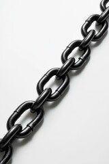 Obraz premium Close-up of a black metal chain on a white background.