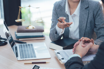 Legal Consultation: A lawyer meticulously explains legal matters to a client in their office. This...