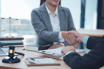 Legal Partnership:  A lawyer and client shake hands, symbolizing trust, collaboration, and a successful legal partnership.  The scene is set in a professional office setting.