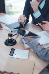 Legal Collaboration: Two business professionals engaged in a serious conversation while reviewing...