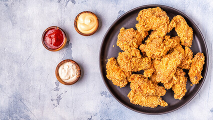 Fried chicken wings with various sauces.