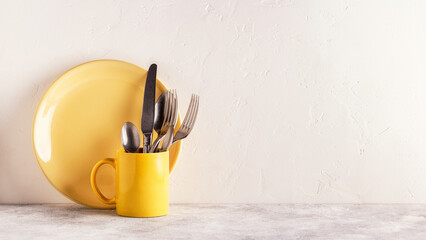 Crockery and cutlery on a light table.