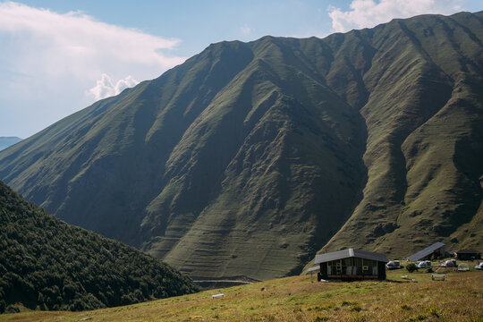 The green mountains of the North Caucasus in Georgia near the village of Juta. A house in the mountains