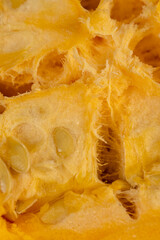 ripe orange pumpkin with seeds cut into pieces