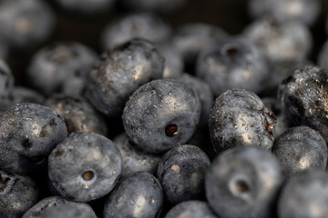a pile of blueberries scattered on the board