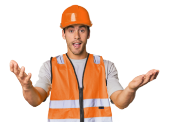 Young Hispanic worker in safety gear receiving a pleasant surprise, excited and raising hands.