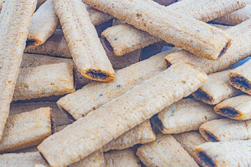 Close-up image of stacked, crisp, seasoned flatbreads against a neutral background