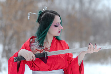 European girl with green hair in a red kimono in winter on the street