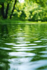 Fototapeta premium Green Water Ripples Reflecting Lush Forest
