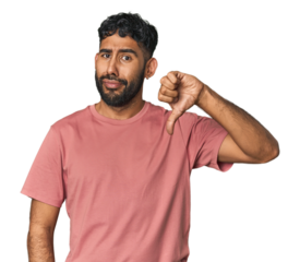 Young Hispanic man isolated showing a dislike gesture, thumbs down. Disagreement concept.