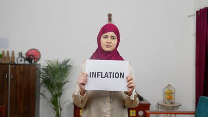 Muslim Woman in Hijab Scarf standing with Inflation Poster
