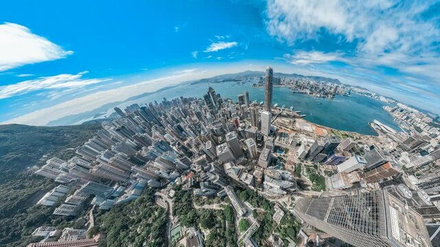 A stunning 4K still video showcases a panoramic view of Hong Kong's central district, the camera panning upward from lush greenery to reveal a dense cityscape and vibrant harbor.