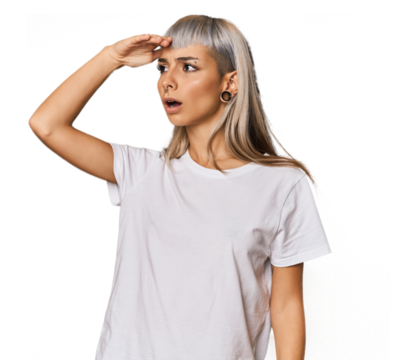 Young caucasian young woman in studio looking far away keeping hand on forehead. - Powered by Adobe