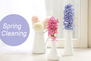 Spring cleaning. Beautiful hyacinths in vases on windowsill