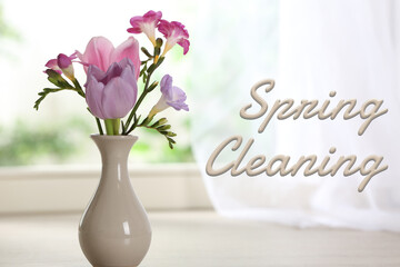 Spring cleaning. Beautiful flowers in vase on windowsill, closeup